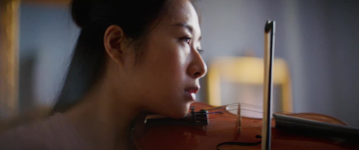 A woman is playing an instrument indoors
