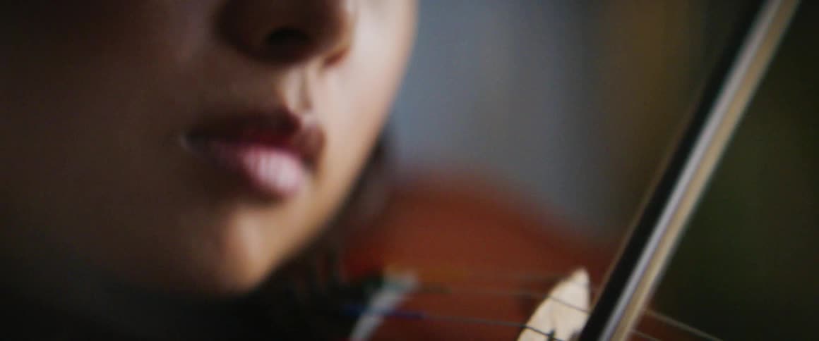 A woman is playing a musical instrument indoors