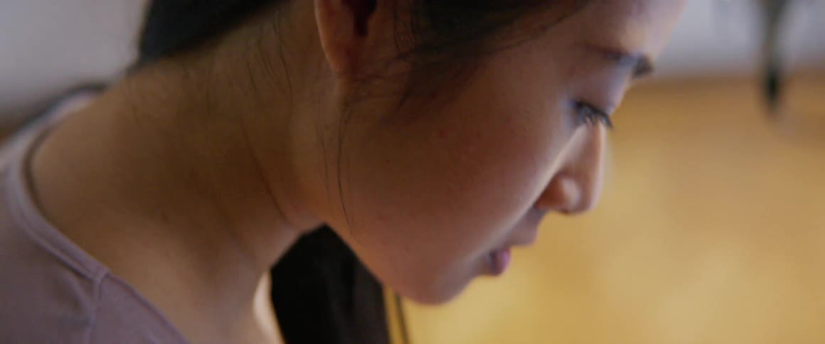A woman is sitting in a room during the day
