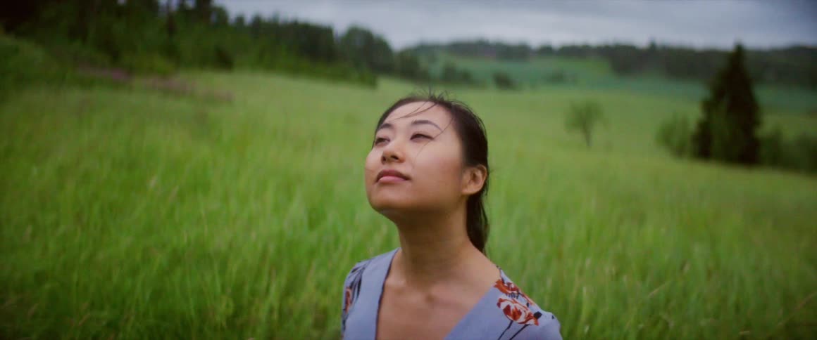 A woman is standing outdoors in spring