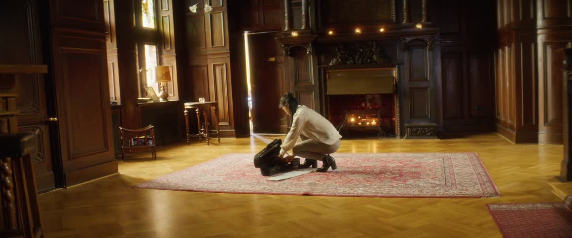 A woman removes her violin from the case