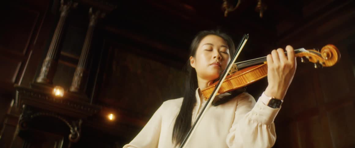 A woman is playing an instrument indoors