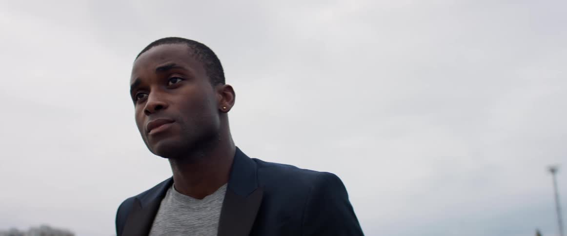 A man is standing outdoors during the day