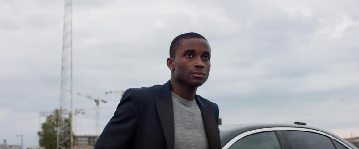 A man is standing by his vehicle outdoors