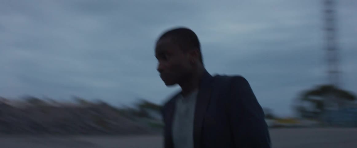 A man puts his head in his hands and turns in circles