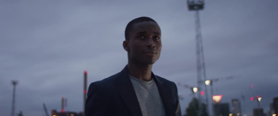 A man stands outside on a cloudy day