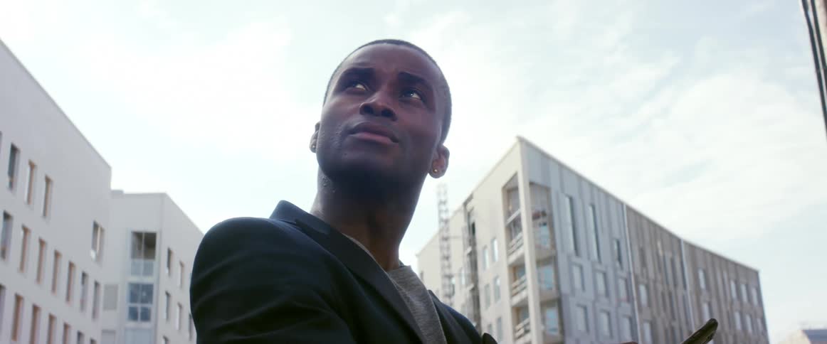 A man is standing outdoors in the city
