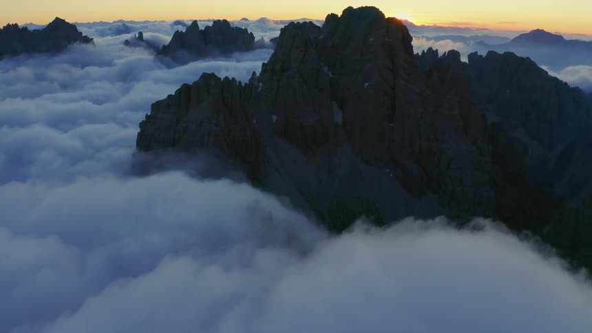 Clouds are covering the mountains at dusk