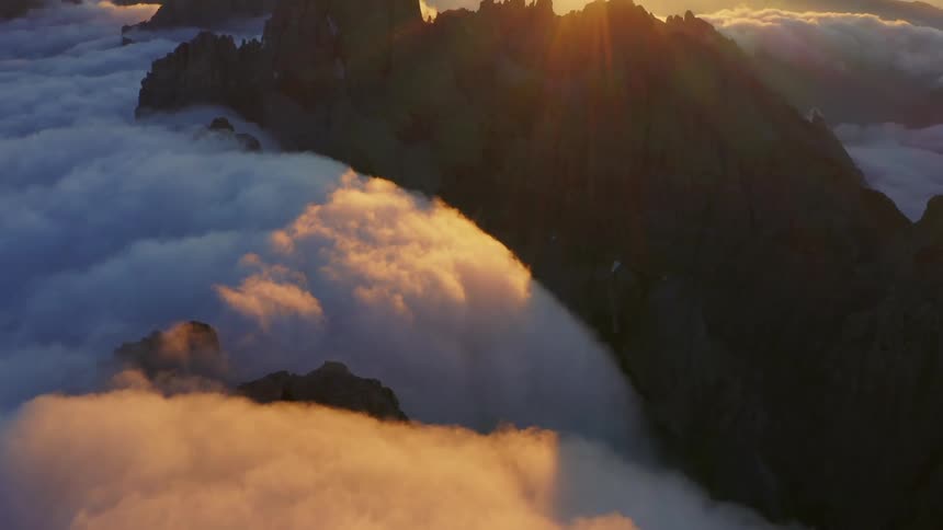 Clouds are covering the mountains at dusk
