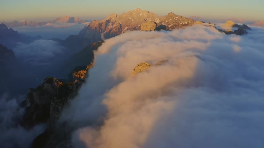 Clouds are covering the mountains at dusk