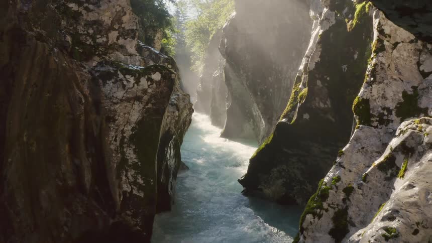 The stream is moving fast between the mountain