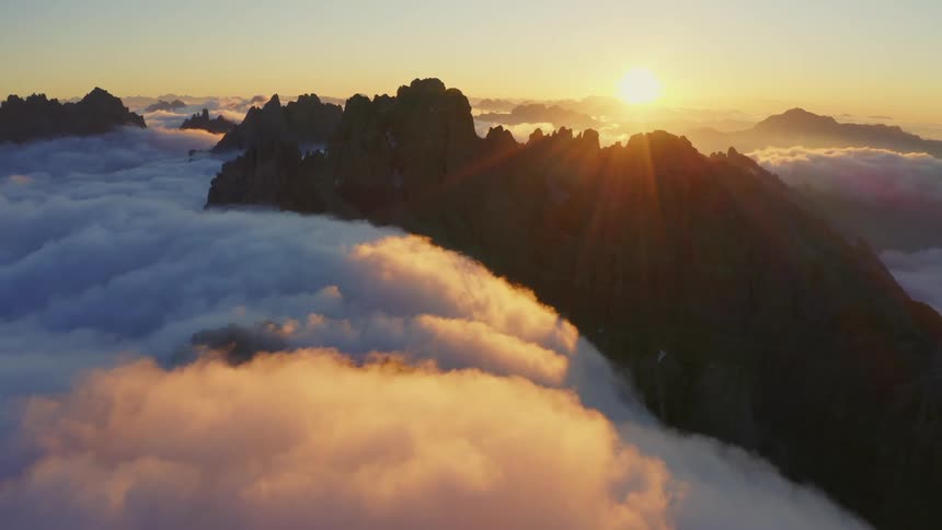 Aerial view of clouds moving over a mountain range
