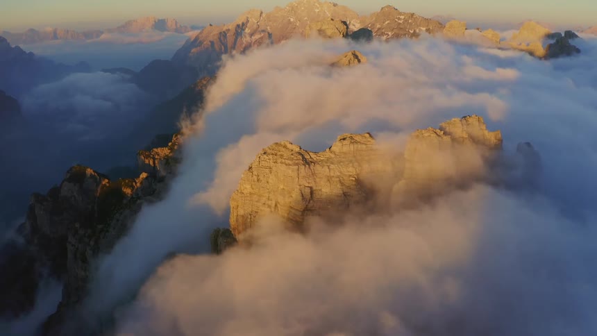 Clouds are covering the mountains at dusk