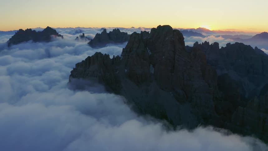Clouds are covering the mountains at dusk