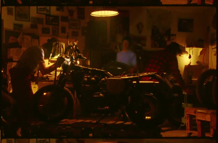 Time lapse of three men putting together a motorcycle