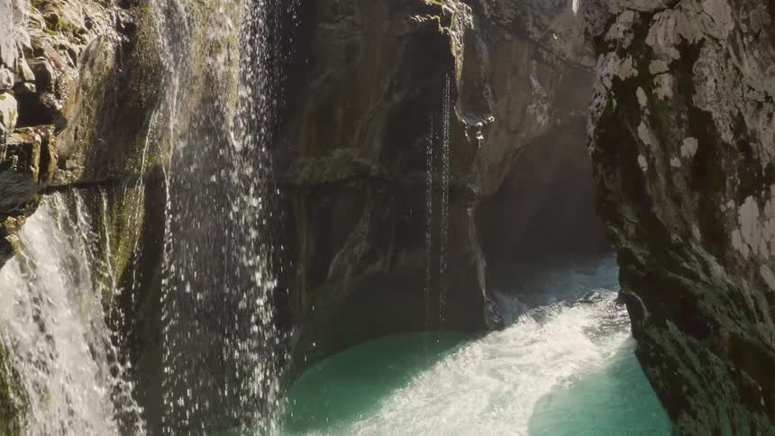 A water fall going over a canyon in to the river below