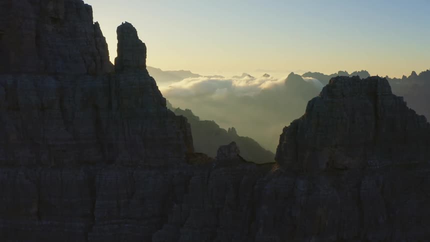 The sun is setting above the mountains in the horizon