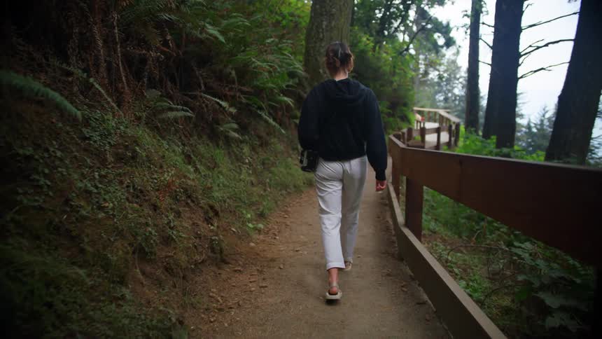 A woman is walking outdoors in the spring time