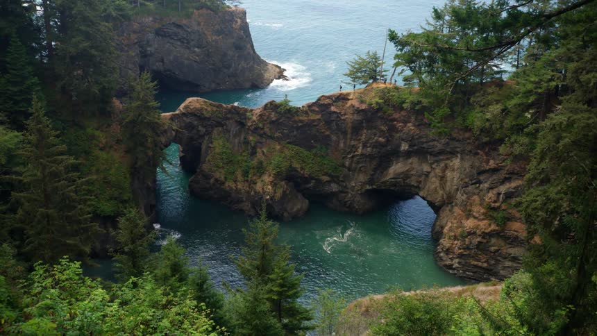 An aerial view of canyons and water at the shore