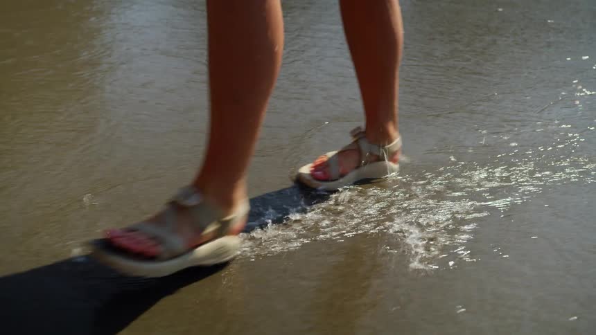 A woman is walking on the beach
