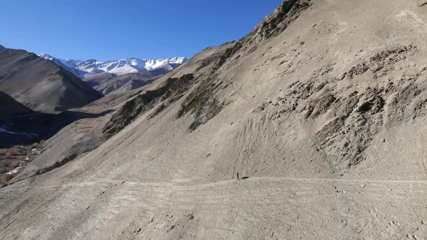 A person hikes up the side of a mountain