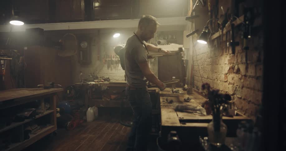 Two man working in a carpentry workshop making chairs