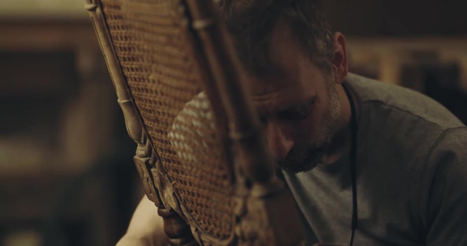 A man staining a chair
