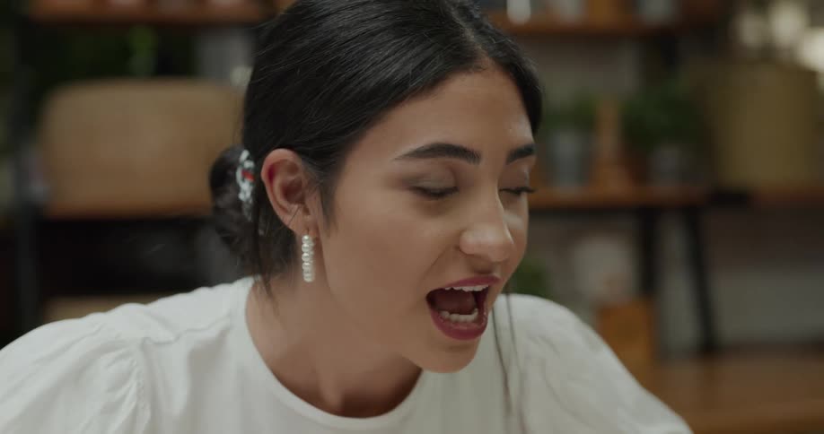 A young woman indoors talking
