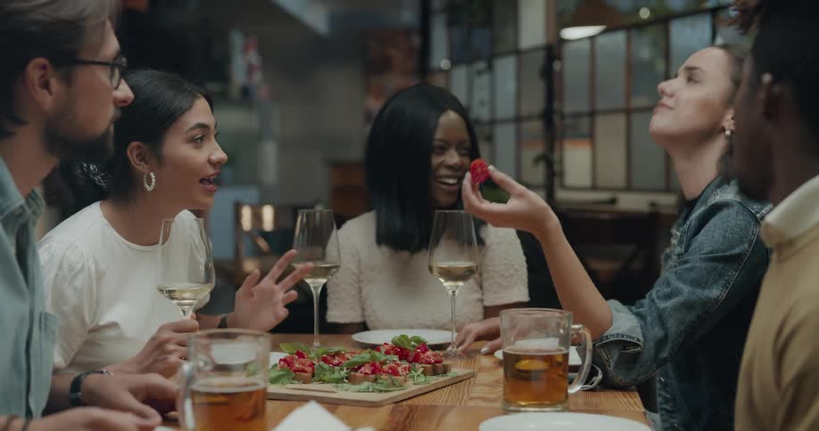 People sitting at a table talking and eating