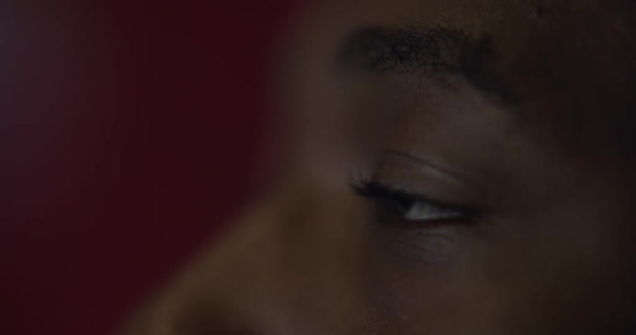 A person blinking their eye and looking forward