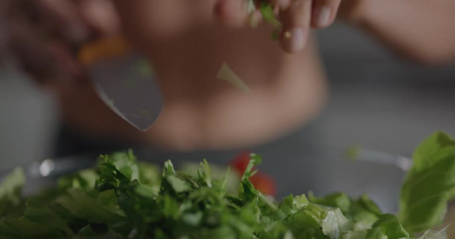 A woman at home making a salad