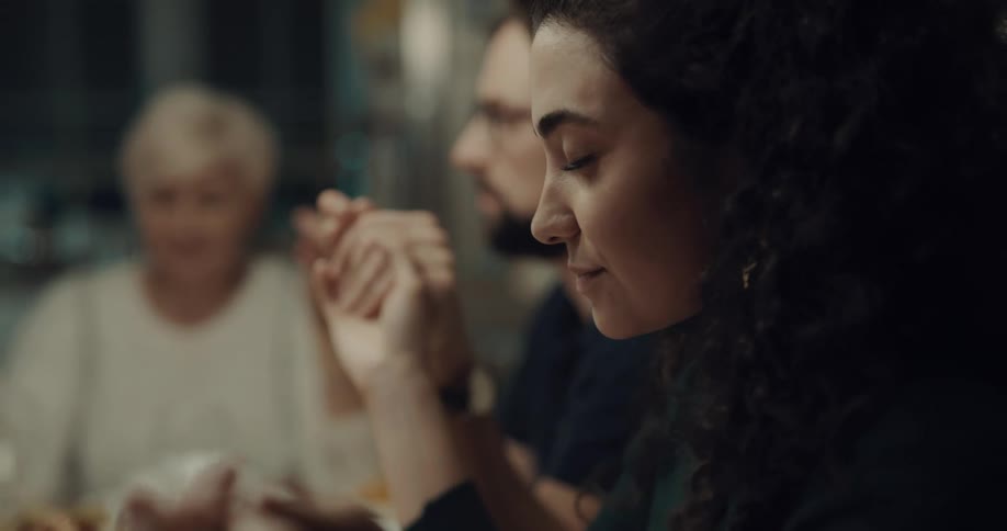A family is saying grace before dinner