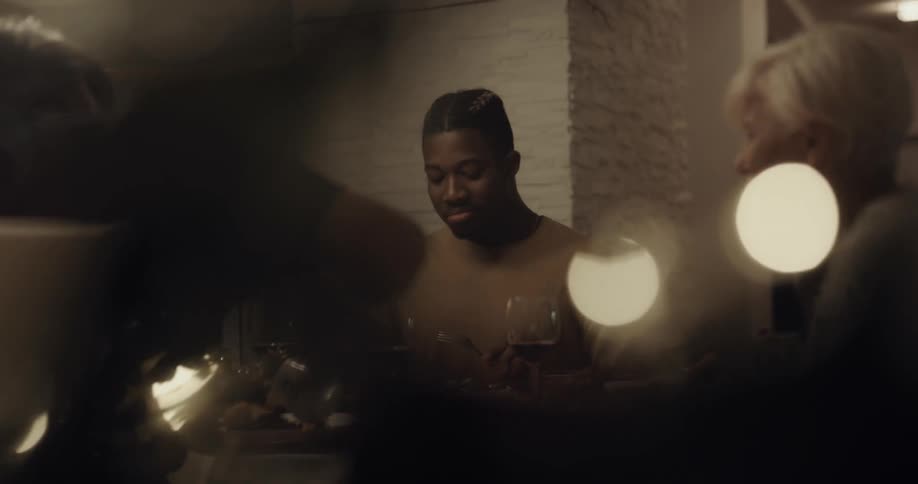 People sitting at the table in a home eating a meal and talking