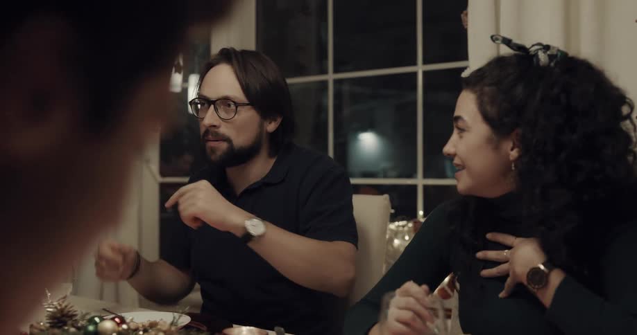 People talking and eating at the dinner table