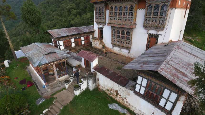 Aerial view of a photographer arriving at a tibetan monastery