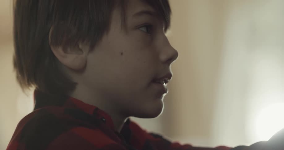 A young boy inside his home