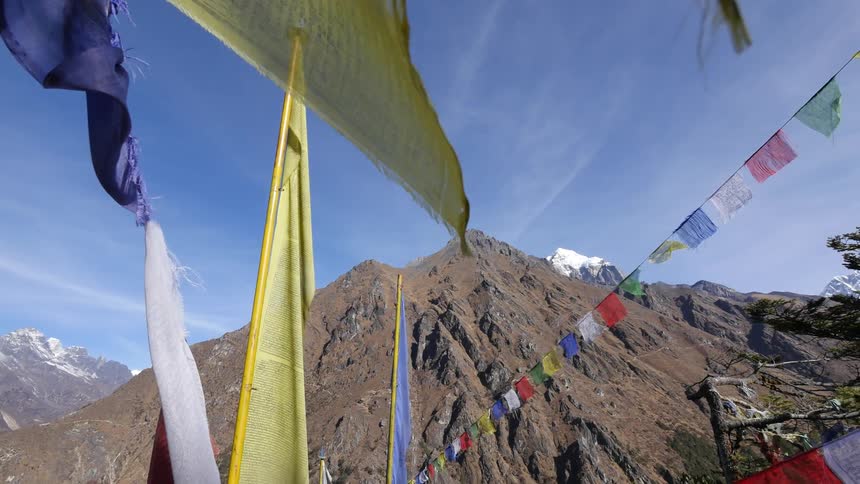 Colored pieces of fabric hanging from rope swaying in the breeze