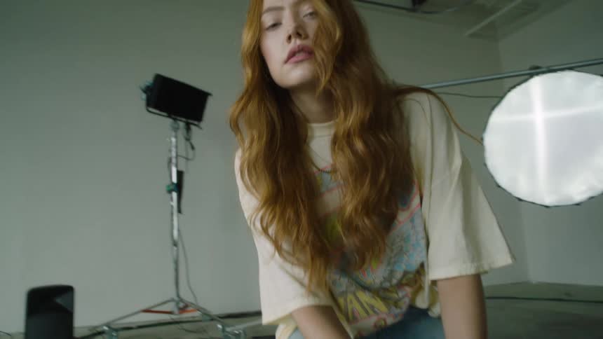 Woman displaying her clothing at a photo shoot
