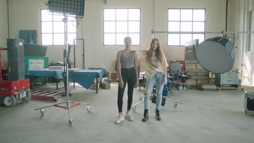 Two women pose together in the studio