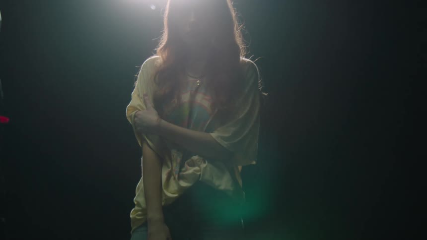 A woman is walking outdoors at night