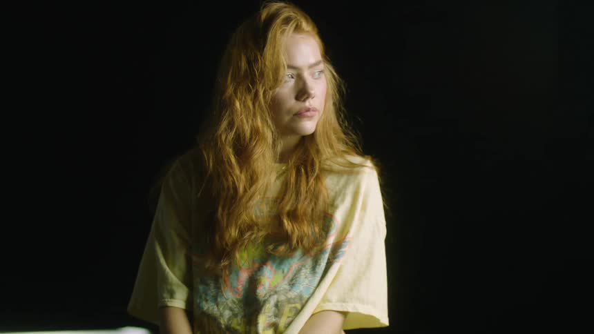 A woman is looking around a room