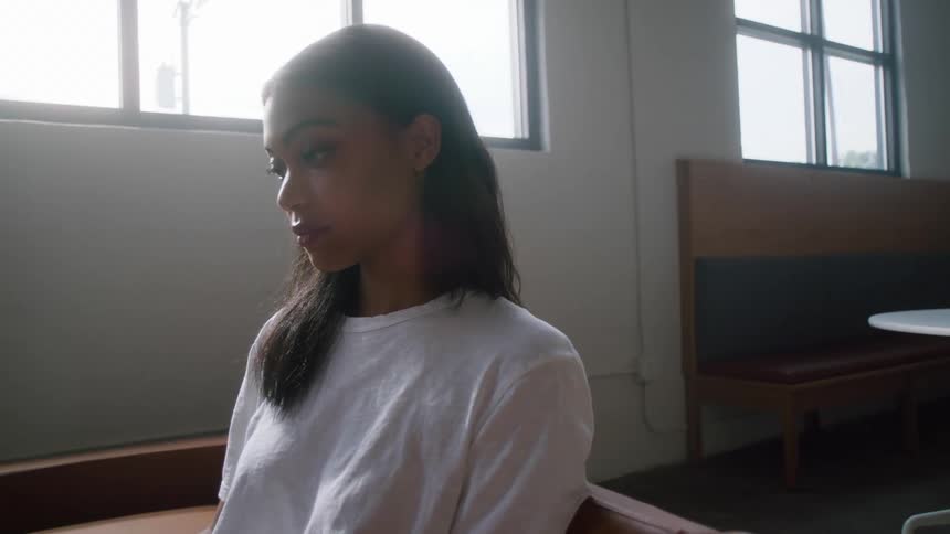 A woman is sitting while looking forward