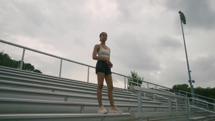 A young woman standing on top of a grandstand