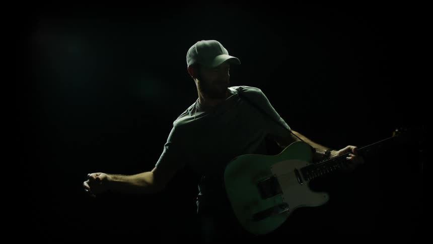 A young man playing the guitar