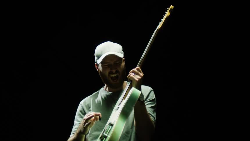 A man is playing guitar and singing