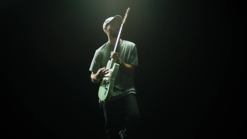 A young man playing the guitar
