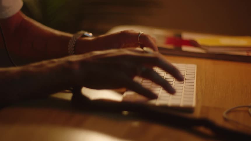 A person types on their keyboard