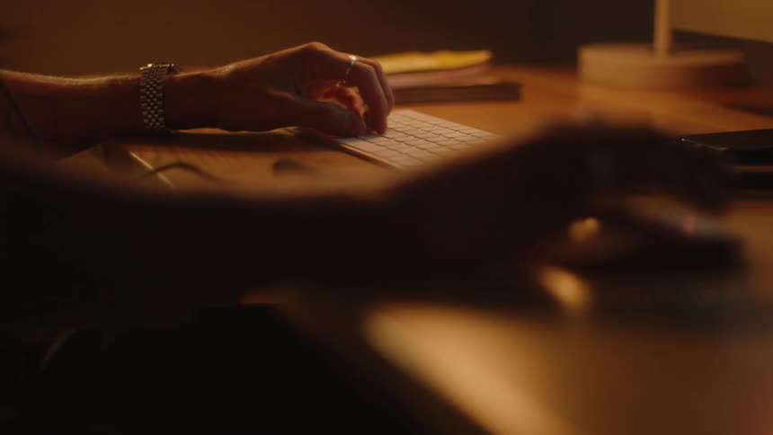 Person typing on keyboard