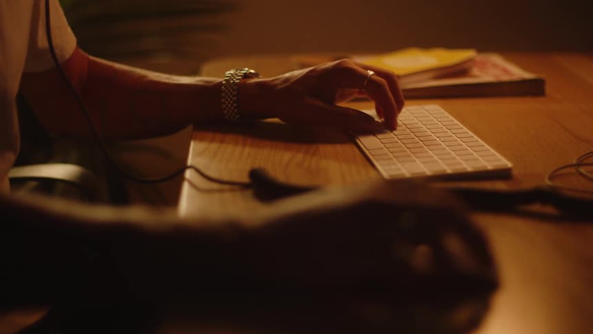 A man is typing on his keyboard