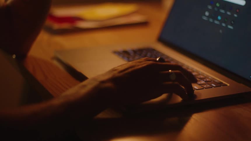 A person typing a query into google on a laptop